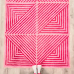 Top view of a contemporary hot pink geometric wool area rug, featuring bold triangular patterns with varying shades of pink stripes. Perfect for large living room rugs or dining room carpets, adding a vibrant touch to any dining room or living room space.