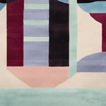 A contemporary hand tufted area rug featuring an abstract geometric design with bold colors including burgundy, light blue, and teal. This wool rug is perfect for adding a modern touch to living room spaces. Ideal for an 8x10 layout, this living room area rug combines style and comfort.