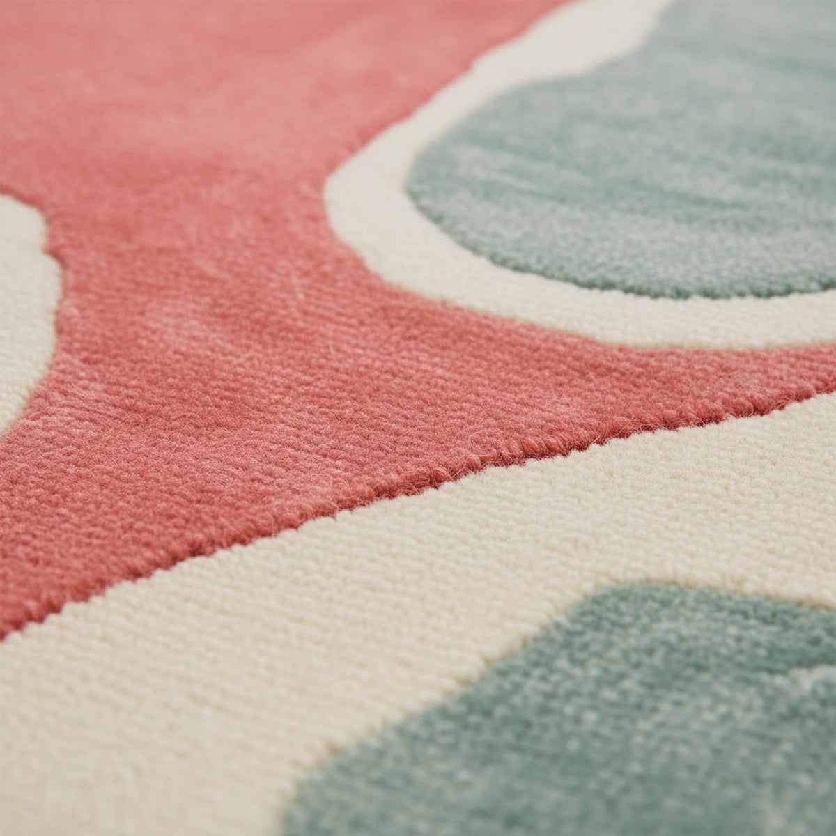 Close-up of a colorful patterned rug with pink, blue, and white shapes.