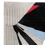 A contemporary hand-tufted wool rug featuring an abstract design with bold black, red, and blue accents, perfect for large living rooms. This area rug combines modern art aesthetics with functionality, making it an ideal choice for those seeking stylish area rugs for living room spaces.