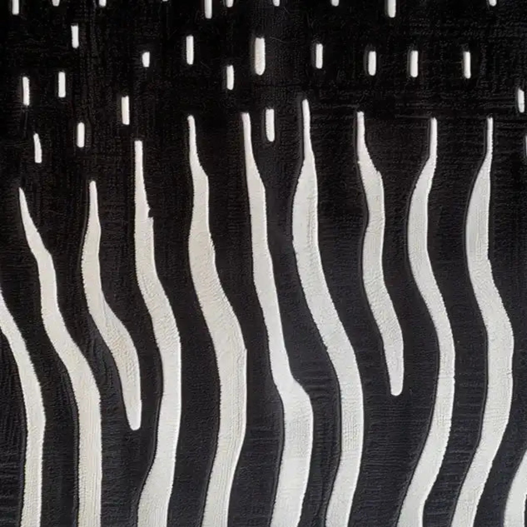 Close-up of the Contrast Currents Hand Tufted Wool Rug, featuring a striking abstract pattern with bold black and white wavy lines, resembling a modern art piece. This area rug showcases intricate texture and design, perfect for adding a contemporary touch to your space.