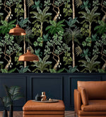 Copper pendants and tan leather seating against jungle foliage palm wallpaper on navy panelling