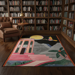 Colorful rug with architectural design in a room with bookshelves and a chair.