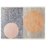 A contemporary hand-tufted wool area rug featuring an abstract design with two large circles in soft pastel colors, set against a textured blue and grey background, ideal for modern home decor.