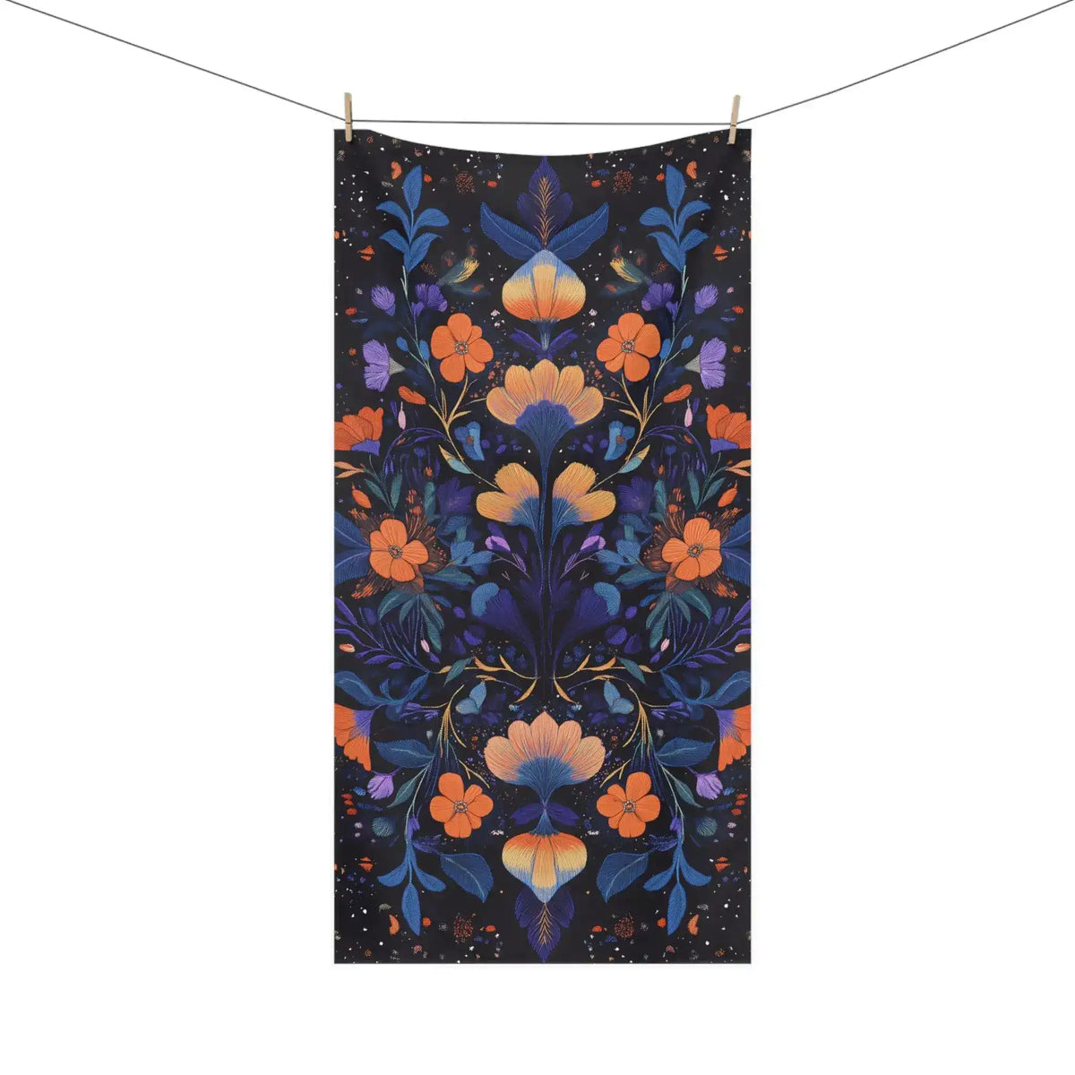 Dark navy bath towel orange and blue floral botanical embroidery symmetrical pattern hanging on line