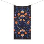 Dark navy bath towel orange and blue floral botanical embroidery symmetrical pattern hanging on line