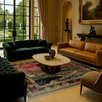 A beautifully decorated living room featuring the Countryside Charm Hand Knotted Area Rug. This vintage wool rug, with its intricate patterns and rich colors, adds a touch of elegance to the space. The square area rug is perfectly placed under a modern coffee table, surrounded by plush sofas, making it an ideal choice for both office and living room settings.