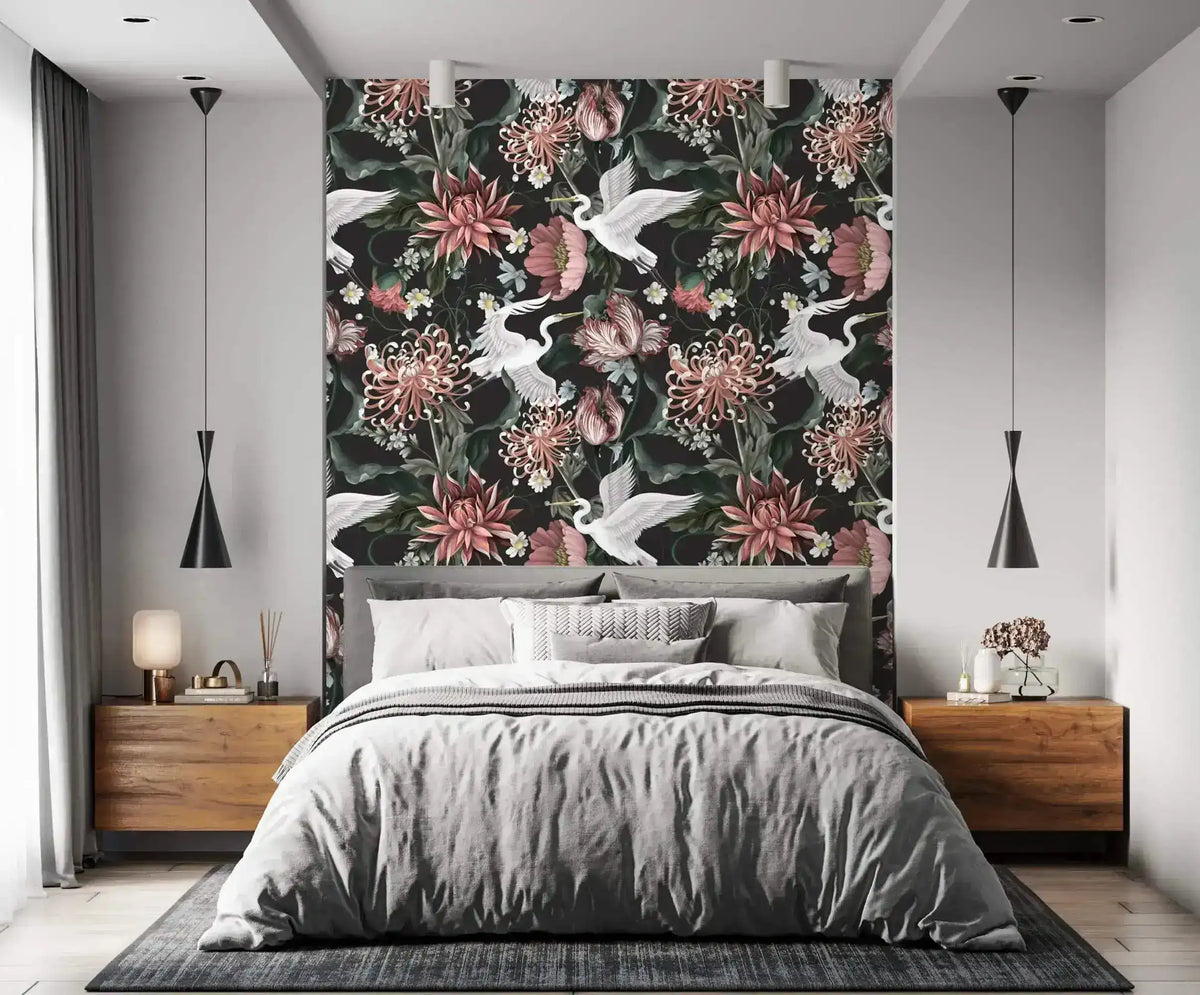 Crane blooms wallpaper as bedroom feature wall behind grey bed with wood nightstands and black cone pendants