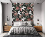 Crane blooms wallpaper as bedroom feature wall behind grey bed with wood nightstands and black cone pendants