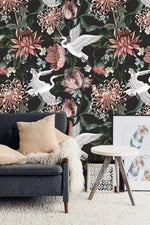 White crane blooms wallpaper installed in living room: flying cranes amid pink chrysanthemums on dark background