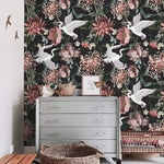Crane blooms wallpaper styled with vintage grey dresser, rattan baskets, and small bird wall ornaments