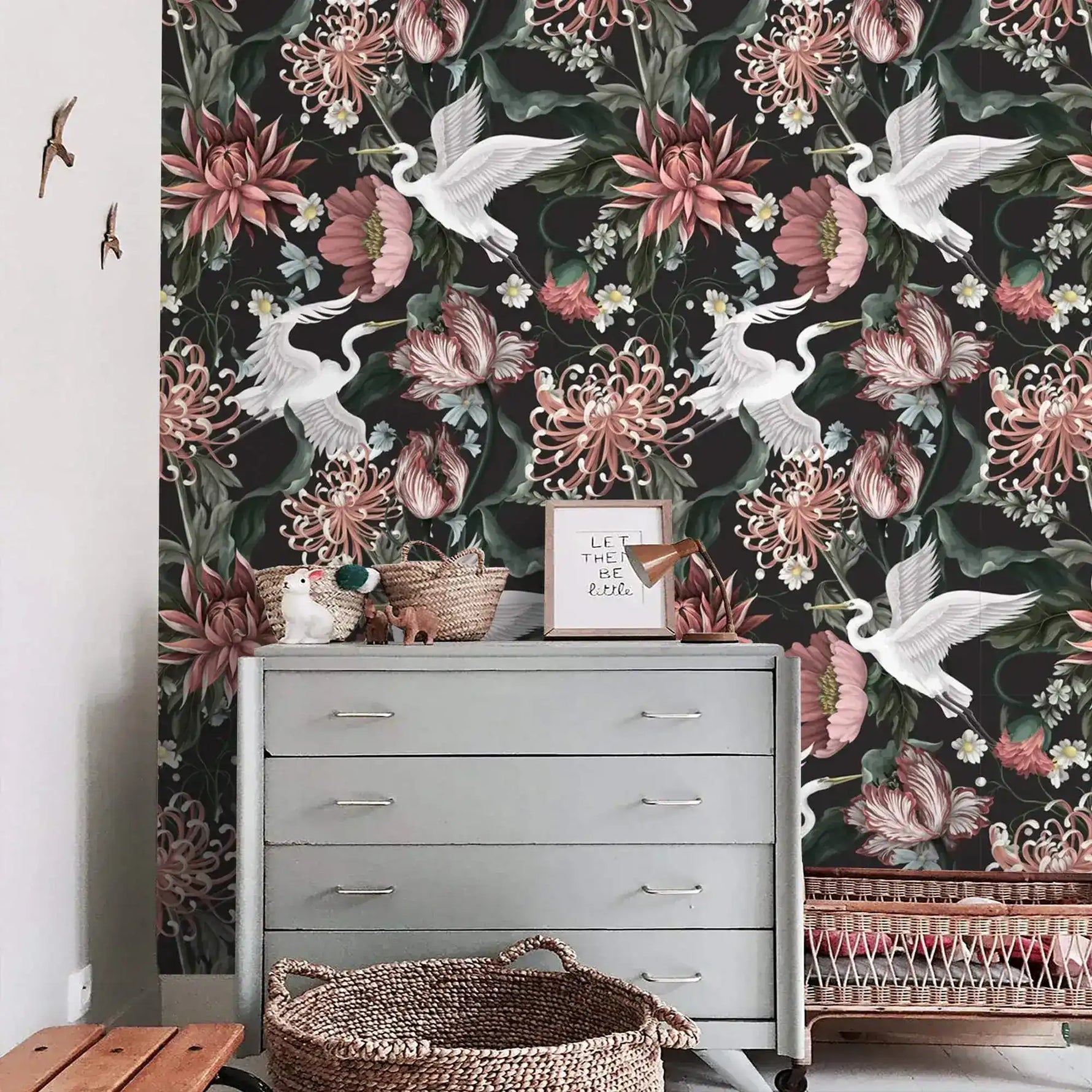 Crane blooms wallpaper styled with vintage grey dresser, rattan baskets, and small bird wall ornaments