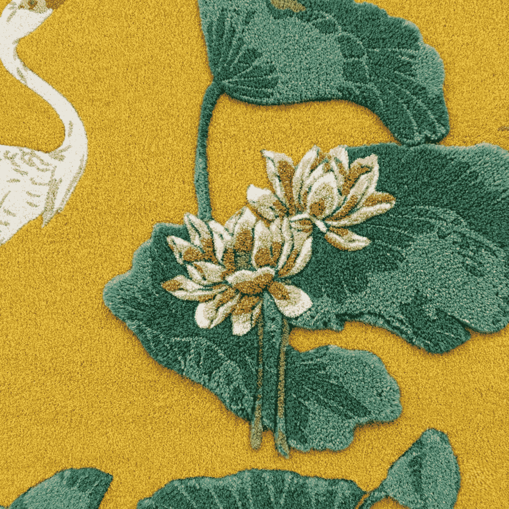 Close-up of a floral rug pattern with green leaves and white flowers on a yellow background