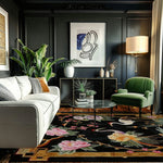 cranes in floral harmony hand tufted rug in a dark-paneled living room with white sofa, green velvet chair and tropical plants