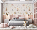 Cream kids wallpaper with woodland animals and teepees in pink child bedroom with grey bed and deer plush
