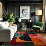 Creative Chaos rug under glass table with white sofa and green velvet chair
