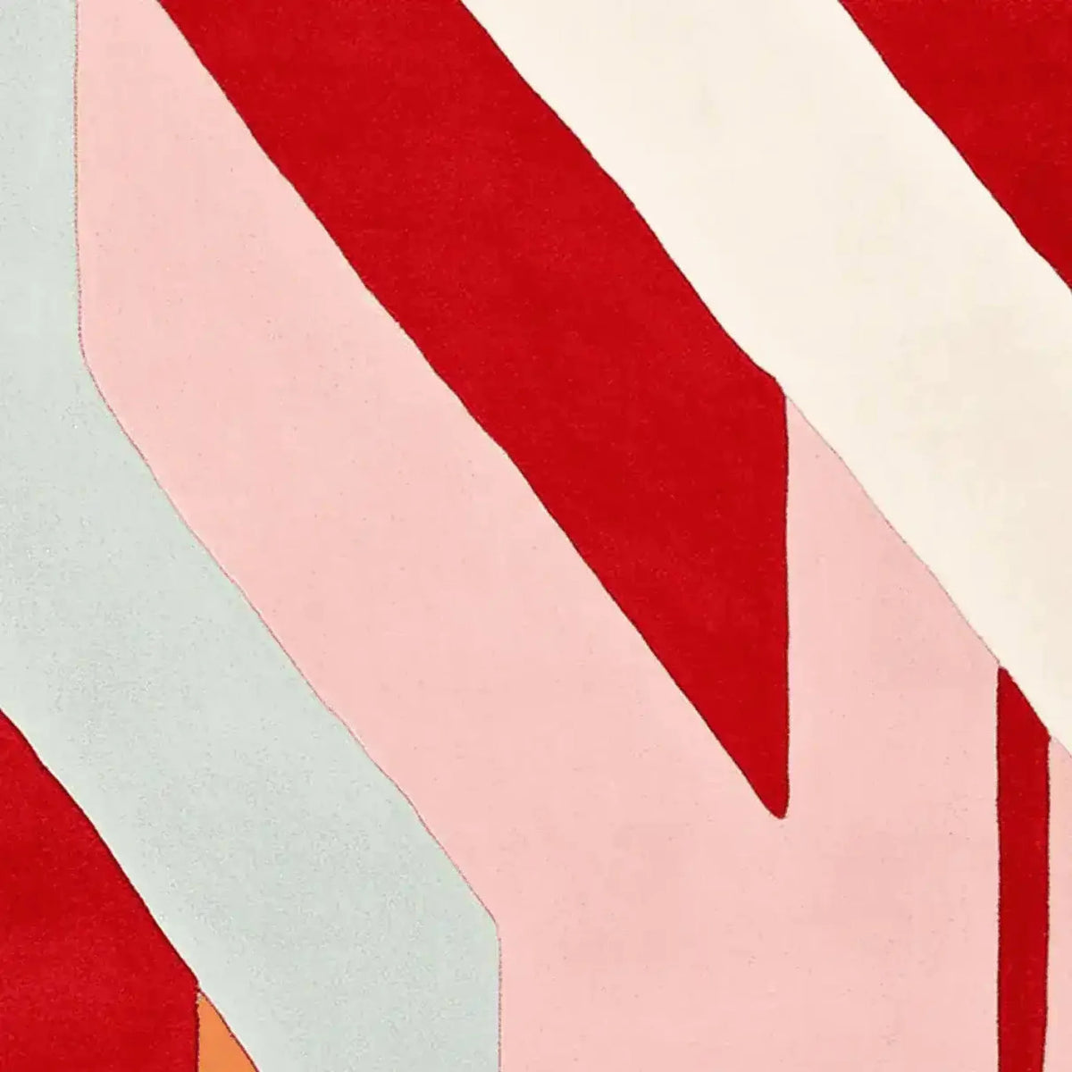 Close-up view of the Crimson Candy Stripes Hand Tufted Area Rug showcasing its vibrant and bold red, pink, and cream stripes. This contemporary rug is perfect for adding a pop of color to any living room. Ideal for spaces needing an 8x10 wool rug.