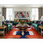 Modern living room with teal sofas, colorful rug, and abstract art.