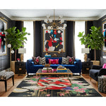 Modern living room with a blue sofa, colorful rug, and abstract art.