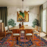 Elegant dining room featuring a Crimson Flora Hand Knotted Rug, a beautiful area rug with a vintage design. This Persian-inspired piece adds warmth and sophistication to large living room spaces, complementing the wooden dining table and modern decor.