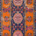 Detailed view of the Crimson Flora Hand Knotted Area Rug showcasing its vibrant orange and pink patterns, perfect for adding a vintage touch to large living room spaces. This Persian-inspired rug features intricate floral motifs that make it an ideal area rug for any living room.