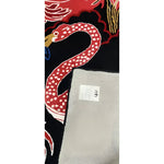 Close-up of the Crimson Paradise Hand Tufted Area Rug, featuring a vibrant red snake design on a black background, perfect for adding a bold touch to living room decor. This wool rug showcases intricate details, making it an ideal choice for those seeking unique living room area rugs.