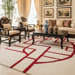 Living room with traditional decor, including a sofa, white and red rug, chairs, and a coffee table.