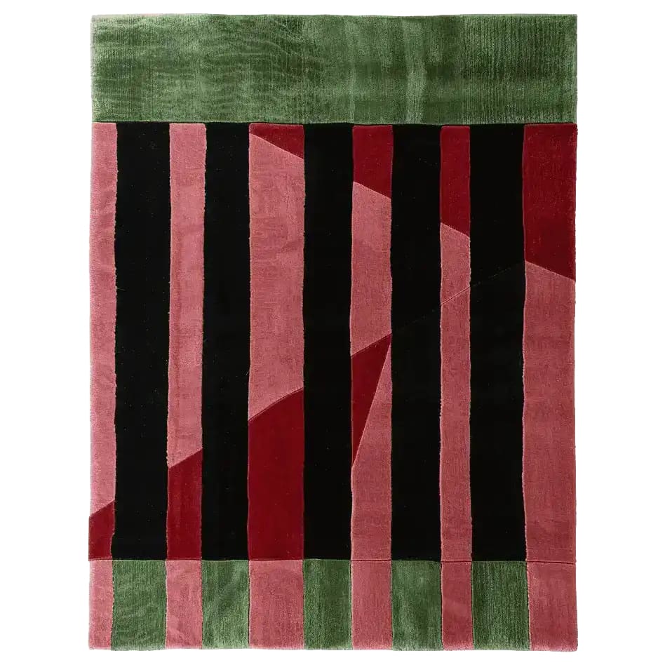 Top view of the Crimson Shadow Columns Hand Tufted Rug, a contemporary area rug perfect for living rooms. The design features bold vertical stripes in black, red, and pink with a green border, crafted from high-quality wool.
