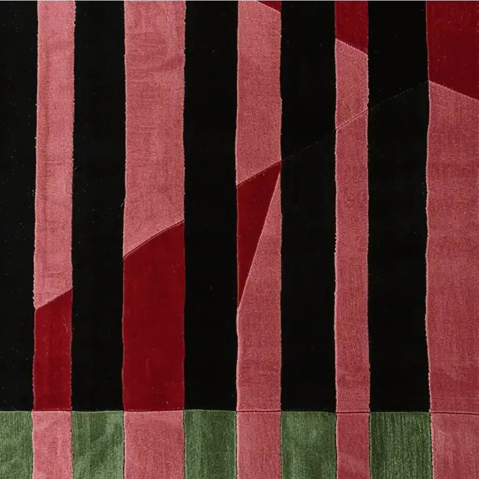 The Crimson Shadow Columns Hand Tufted Rug showcases a bold abstract design with red and black geometric patterns, perfect for adding a contemporary touch to any living room. This wool area rug combines style and comfort, making it an ideal choice for those seeking unique rugs for their living room decor.