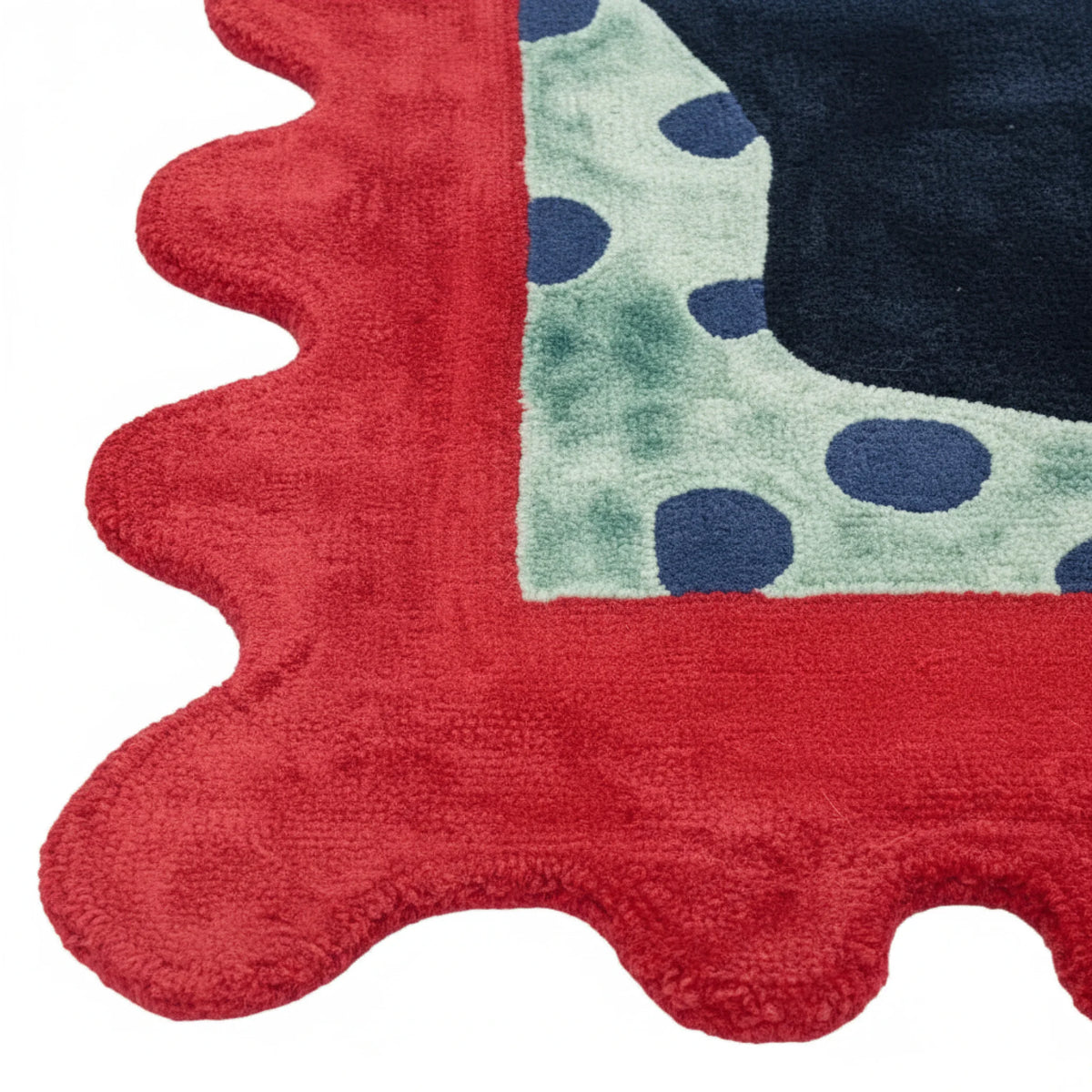 Close-up of a colorful children's rug with red, green, and blue patterns.