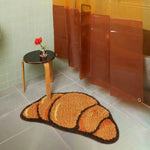 A Croissant Shaped Bathmat is a unique and playful home accessory designed to bring a touch of fun and creativity to your bathroom. Shaped like a croissant, the mat typically features a soft, plush texture, often made from high-quality materials like cotton, microfiber, or a blend of fabrics for maximum comfort and absorbency. The shape mimics the iconic crescent curve of a croissant, with some designs even incorporating realistic details like texture patterns to enhance its appeal.