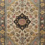 A beautifully intricate hand-tufted wool rug, ideal as a large area rug for living rooms and dining rooms. This Cultural Legacy rug features a rich, traditional pattern with floral motifs in warm tones, perfect for adding elegance to any dining room or as a standout piece in your living room.