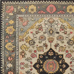 A detailed view of a Cultural Legacy Hand Tufted Rug, featuring intricate floral patterns in warm tones, ideal for use as a large area rug in living rooms or dining rooms. This wool rug showcases a traditional design, perfect for enhancing the ambiance of any space with its elegant border and vibrant colors.