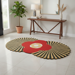 Decorative round rug with a sunburst pattern in a room with a wooden console table and plant.