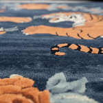 Close-up of a textured fabric with tiger designs on a blue background