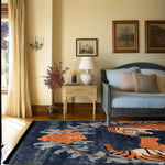 Elegant living room featuring a 'Dance of the Wild' hand tufted area rug. This vintage floral wool rug, measuring 8x10, showcases a striking abstract tiger design, perfect for adding a stylish touch to large living rooms.