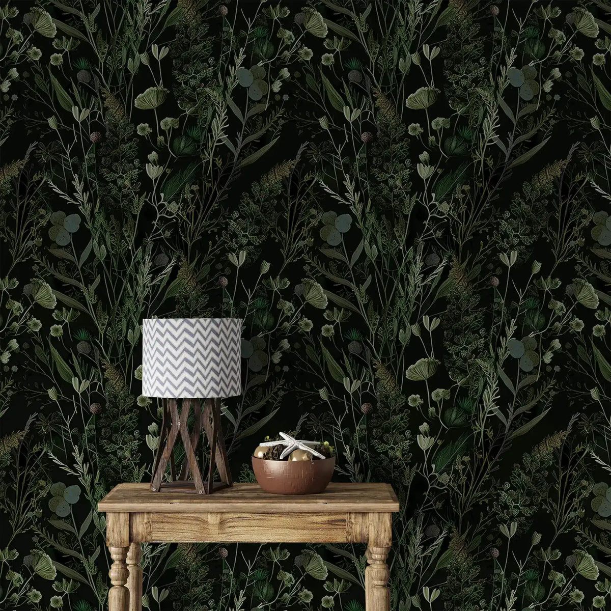 Dark fern and wildflower wallpaper behind rustic wood table with chevron lamp and bowl