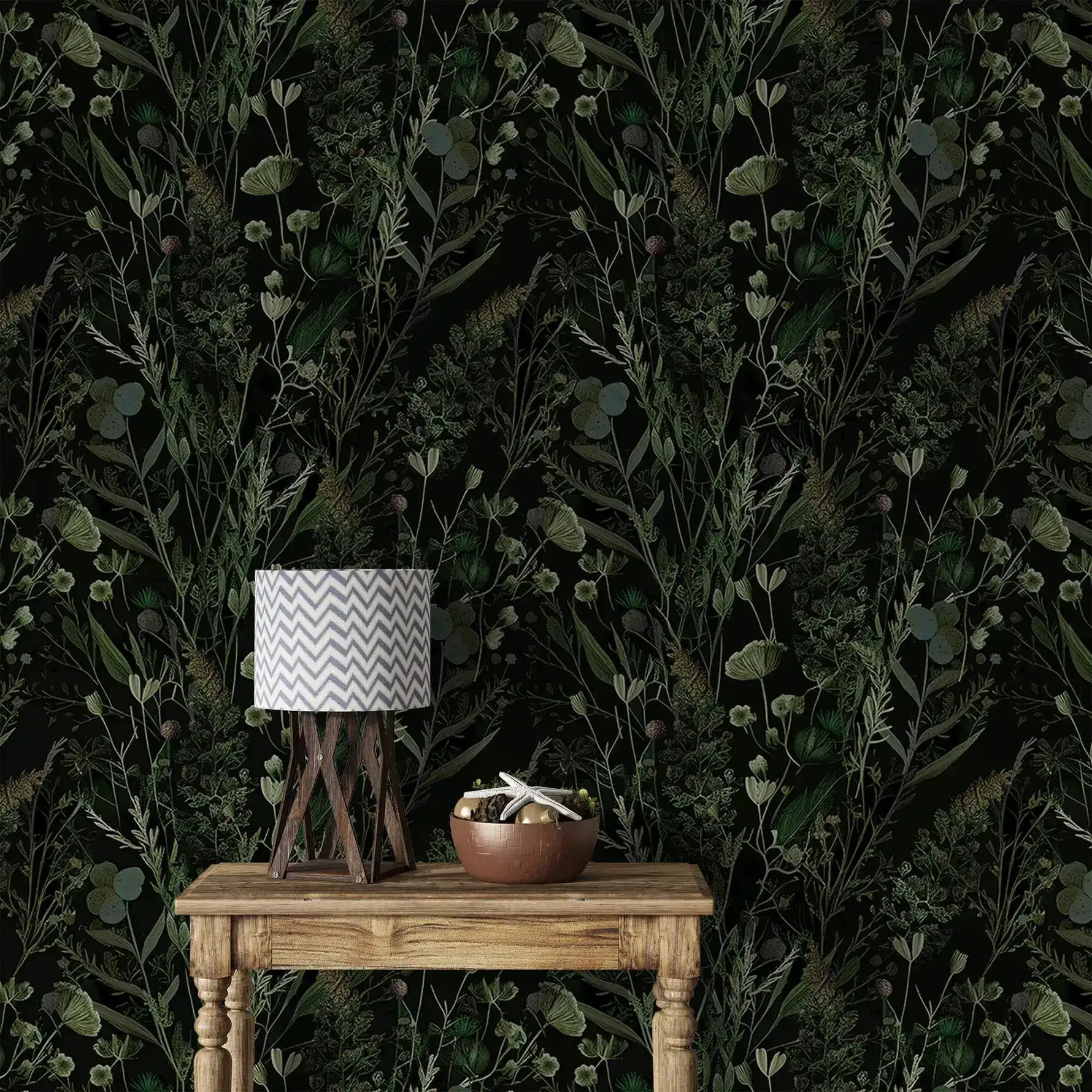 Dark fern and wildflower wallpaper behind rustic wood table with chevron lamp and bowl