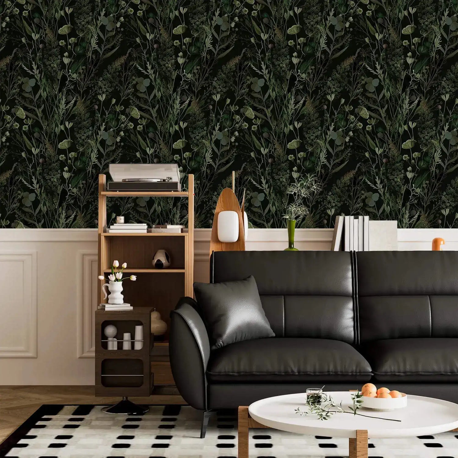 Dark fern botanical wallpaper above white panelling in living room with black leather sofa and shelf