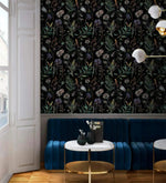 Dark floral fern wallpaper in cafe nook with blue velvet banquette, marble table and brass lamp