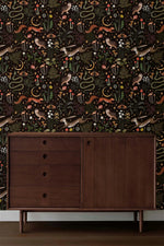 Dark forest fantasy wallpaper in room setting; dark background with owls, squirrels, snakes, mushrooms, ferns, stars