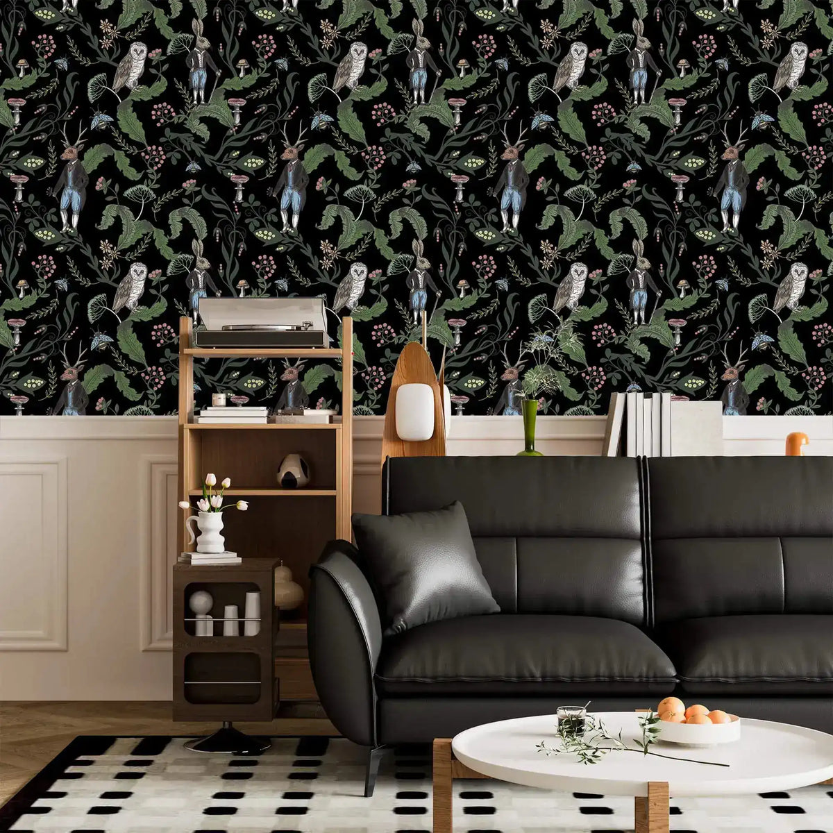 Dark woodland wallpaper with owls and hares on black above wainscoting in a living room with black sofa