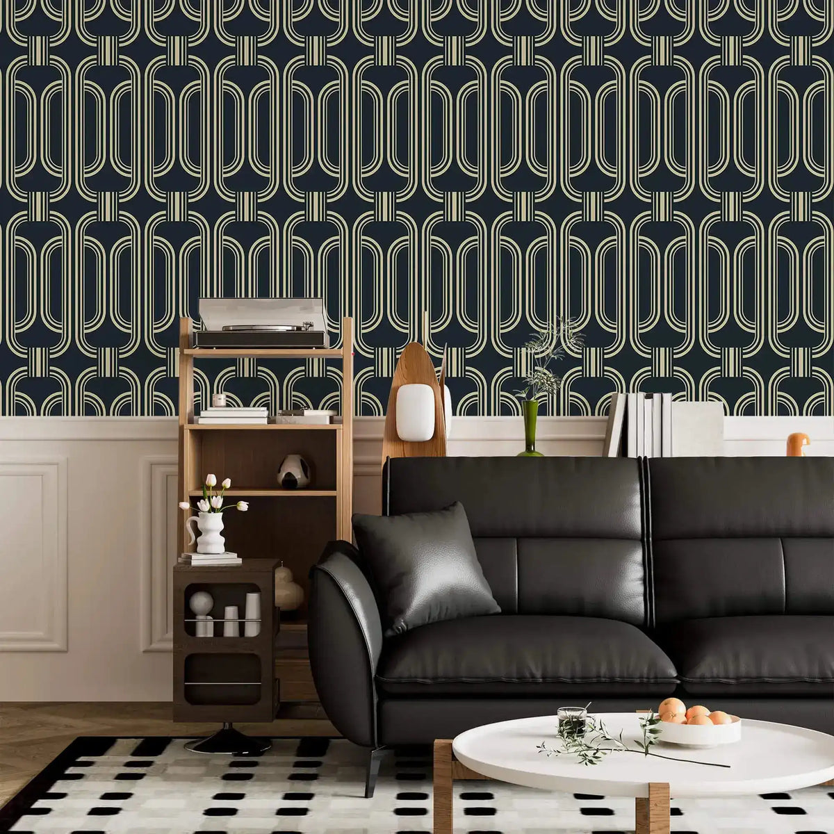 Deco geometric wallpaper with gold linked-oval lines on navy above wainscoting in a living room with black sofa
