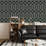 Deco geometric wallpaper with gold linked-oval lines on navy above wainscoting in a living room with black sofa