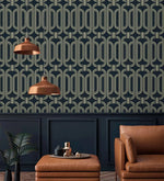 Deco geometric wallpaper with gold linked-oval lines on navy above panelling with copper pendant lights