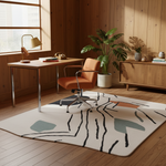 Modern home office with a desk, chair, and decorative rug.