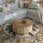 A beautiful Desert Paradise Hand Tufted Round Rug placed in a large living room setting. This wool rug features intricate palm tree and floral designs, bringing a touch of elegance and warmth to the space. Perfect for those seeking large area rugs for living room decor.