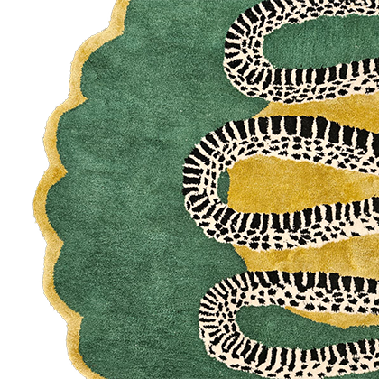 Detail of snake rug scalloped border, serpent coils over gold patches on emerald green wool