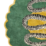 Detail of snake rug scalloped border, serpent coils over gold patches on emerald green wool