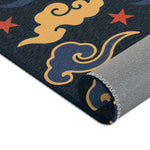 Detail of the Retro Night Sky Accent Rug, swirling gold and blue clouds on dark navy